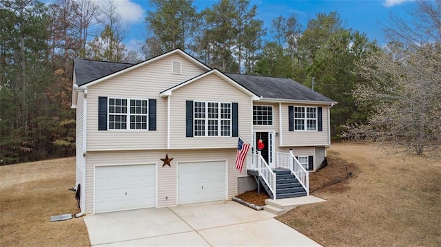 split foyer home with concrete driveway and a garage