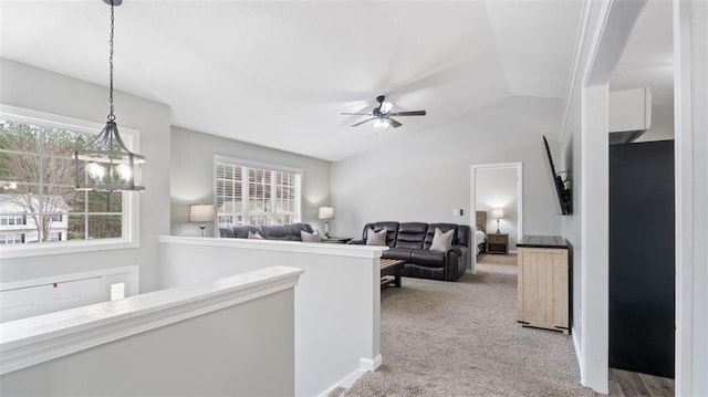 hall with carpet floors, an upstairs landing, and vaulted ceiling