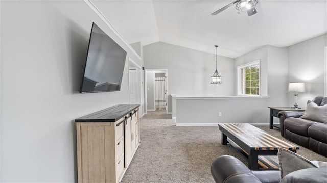 living room featuring baseboards, light carpet, ceiling fan with notable chandelier, and vaulted ceiling