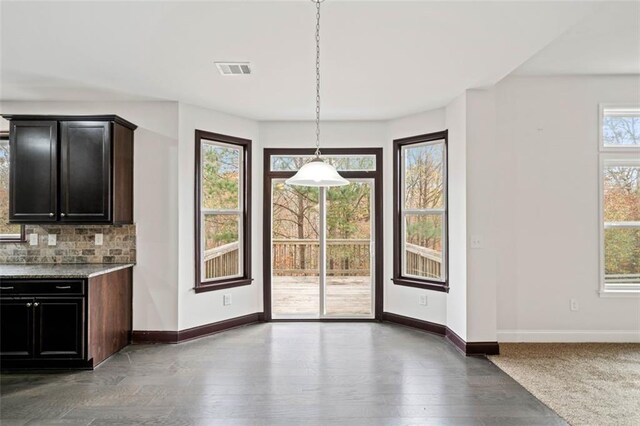 interior space with wood-type flooring and a healthy amount of sunlight