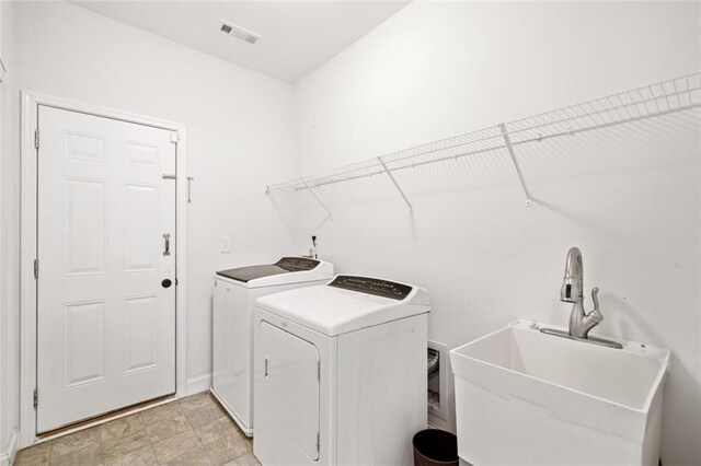 laundry room with washer and clothes dryer and sink