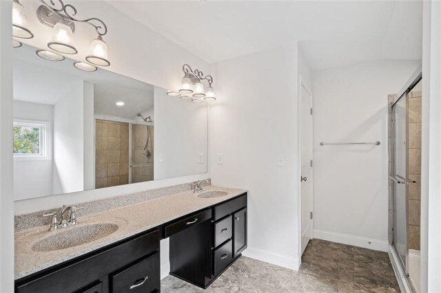 bathroom with vanity and a shower with door