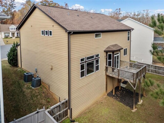 back of property featuring a wooden deck and central AC