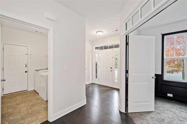 entrance foyer featuring independent washer and dryer and wood-type flooring