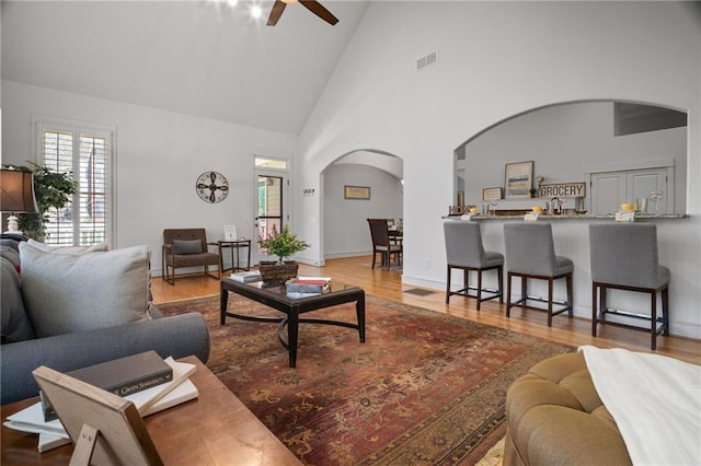 216 Crescent Moon Way, Canton, GA 30114 - living area featuring arched walkways, visible vents, a ceiling fan, and wood finished floors
