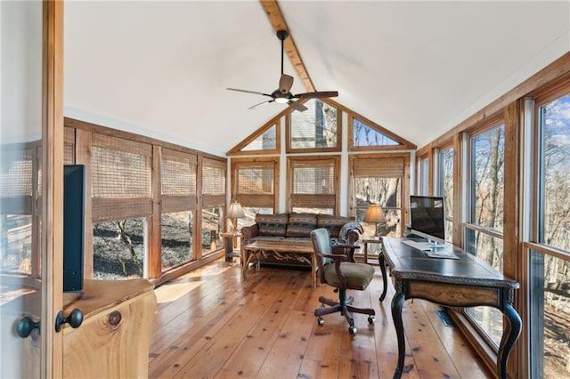 home office with a ceiling fan, wood-type flooring, and vaulted ceiling