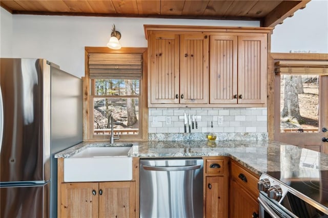 kitchen with light stone counters, wooden ceiling, a sink, appliances with stainless steel finishes, and decorative backsplash