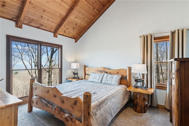 carpeted bedroom featuring vaulted ceiling with beams and wooden ceiling