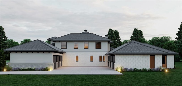 view of front of home with a patio area and a front yard