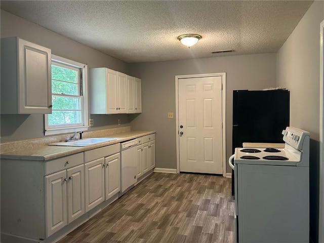 319 Gordon St, Rockmart, GA 30153 - kitchen featuring a sink, white appliances, a textured ceiling, and wood finished floors