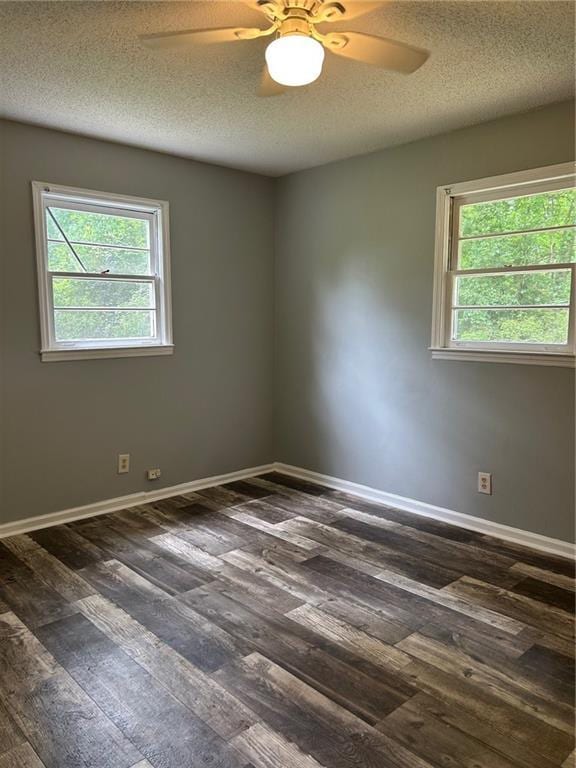 319 Gordon St, Rockmart, GA 30153 - empty room featuring plenty of natural light, a ceiling fan, a textured ceiling, and dark wood-type flooring