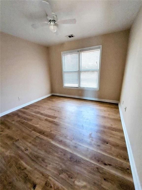 empty room with hardwood / wood-style flooring and ceiling fan