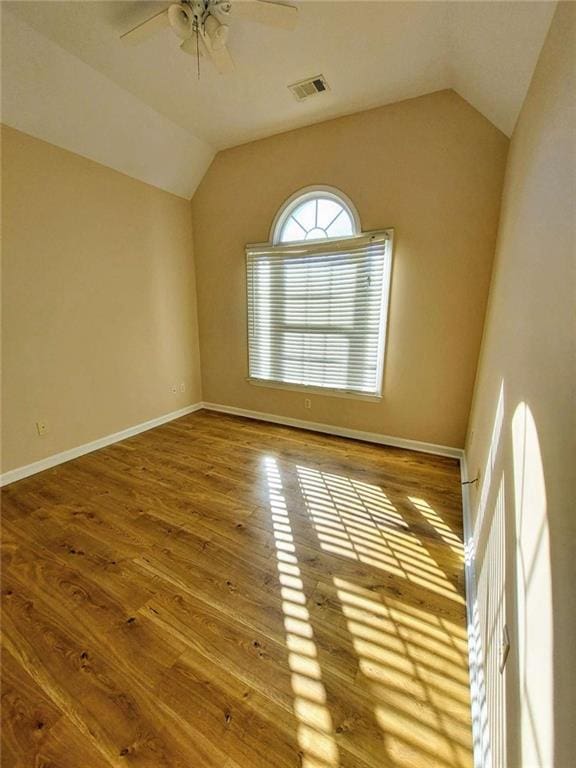 spare room with wood-type flooring, ceiling fan, and lofted ceiling