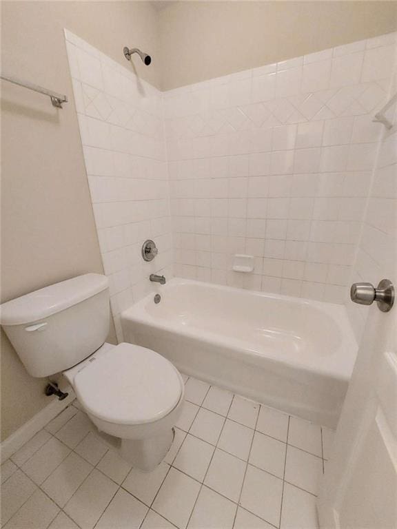 bathroom with toilet,  shower combination, and tile patterned floors