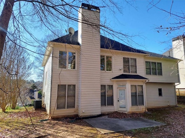 rear view of property with central AC unit and a patio area