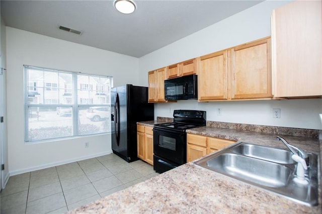 kitchen with visible vents, light brown cabinetry, black appliances, a sink, and light tile patterned flooring