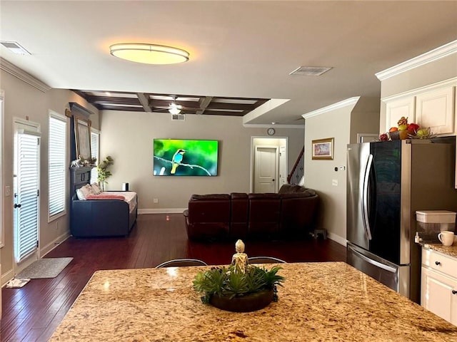 living area featuring coffered ceiling, dark wood finished floors, baseboards, ornamental molding, and ceiling fan