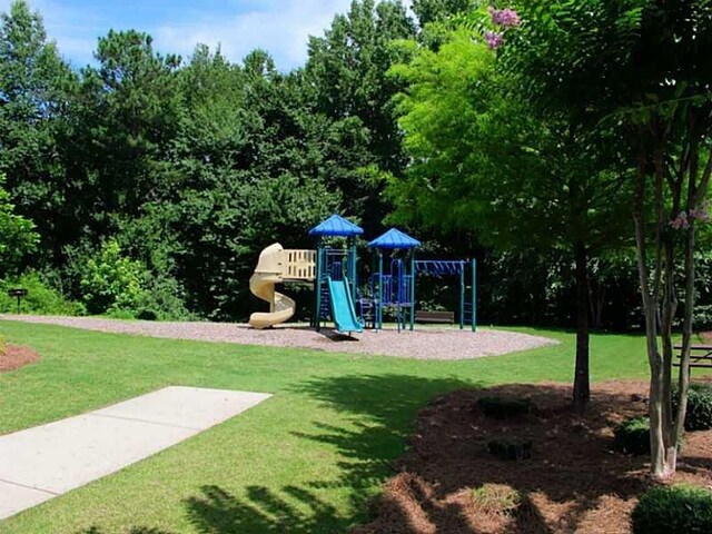 community jungle gym with a lawn