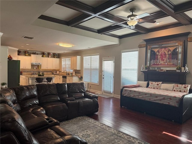 living area featuring ceiling fan, baseboards, coffered ceiling, dark wood-style flooring, and ornamental molding