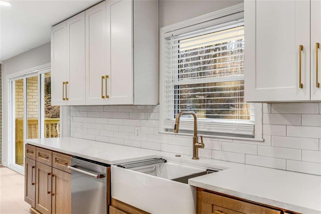 kitchen featuring white cabinets, light countertops, and backsplash