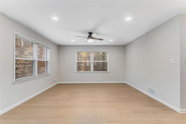 spare room featuring ceiling fan, light wood finished floors, recessed lighting, and baseboards