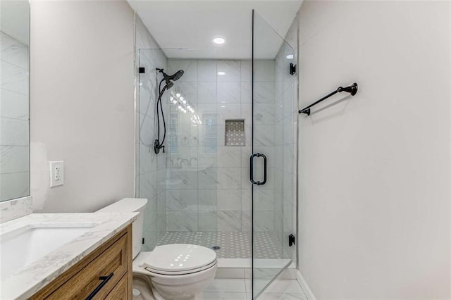 full bathroom featuring baseboards, toilet, vanity, a shower stall, and recessed lighting