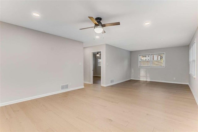 empty room with recessed lighting, baseboards, visible vents, and light wood finished floors