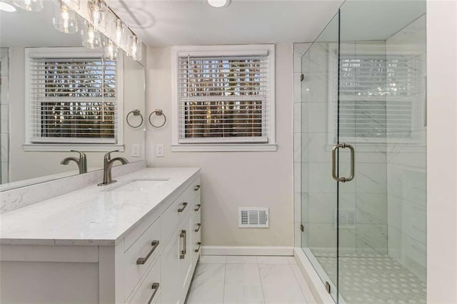 full bath with baseboards, visible vents, marble finish floor, vanity, and a shower stall