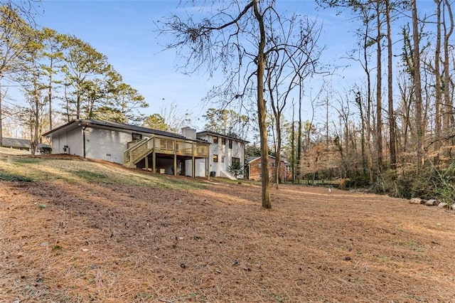 exterior space featuring a wooden deck and stairs