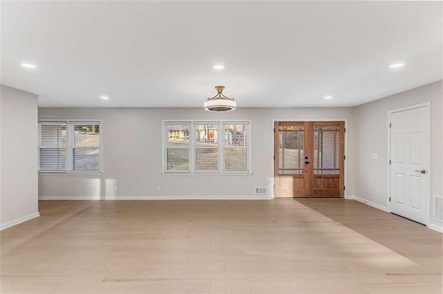 interior space featuring recessed lighting, french doors, light wood-style flooring, and baseboards