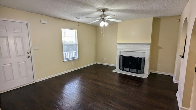 4707 Golod Way, Lithonia, GA 30038 - unfurnished living room with ceiling fan, wood finished floors, a textured ceiling, a fireplace with flush hearth, and arched walkways