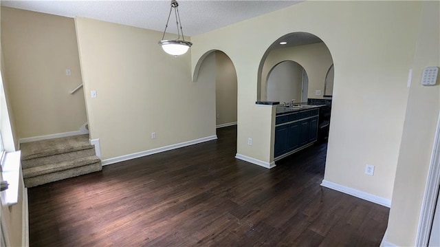4707 Golod Way, Lithonia, GA 30038 - spare room featuring dark wood finished floors, arched walkways, and stairs