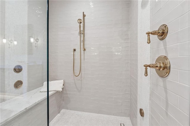 full bath with a tile shower