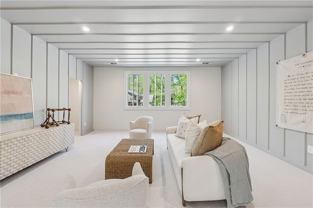 living room featuring carpet floors, recessed lighting, and beamed ceiling
