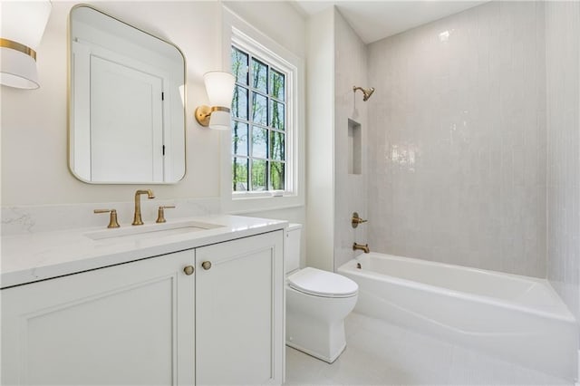 bathroom featuring toilet, vanity, and bathtub / shower combination