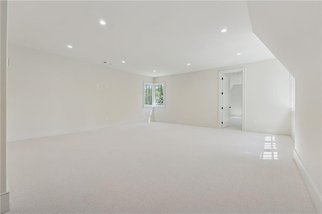 carpeted spare room featuring baseboards and recessed lighting