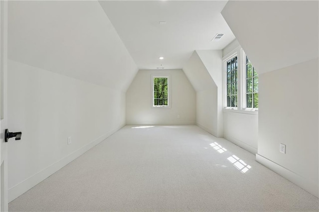 bonus room with visible vents, baseboards, lofted ceiling, and carpet floors