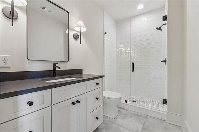 bathroom featuring a shower stall, vanity, tile patterned flooring, visible vents, and toilet