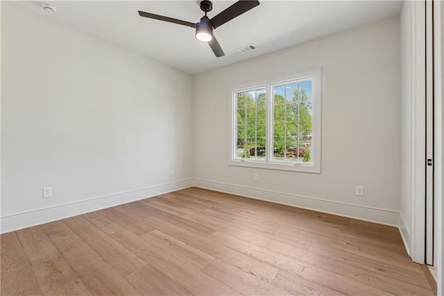 unfurnished room with light wood finished floors, visible vents, baseboards, and ceiling fan