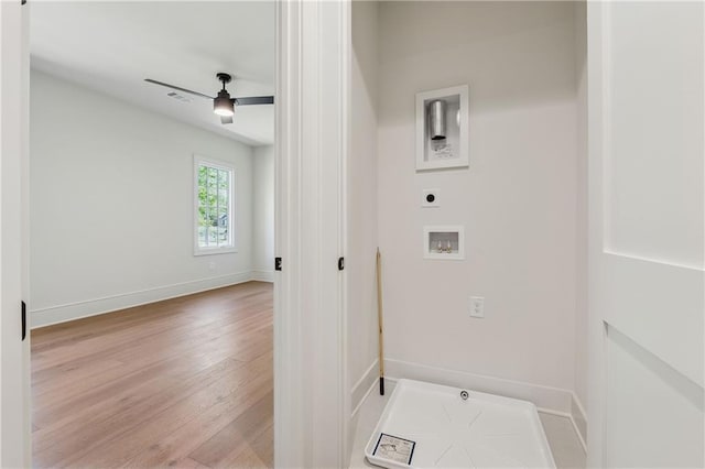 clothes washing area with laundry area, hookup for a washing machine, wood finished floors, hookup for an electric dryer, and baseboards