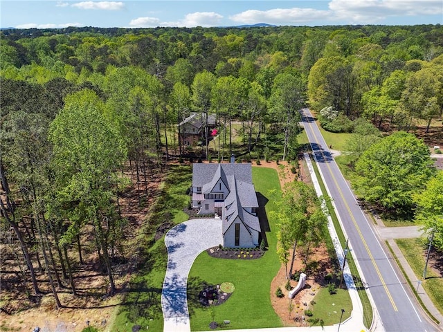drone / aerial view featuring a forest view
