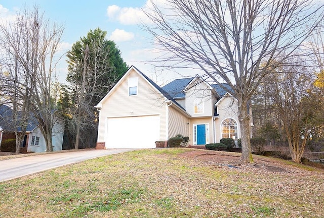 front facade with a garage and a front lawn