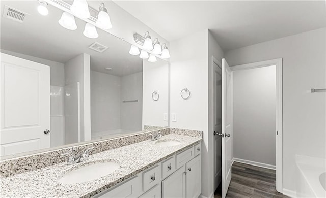 bathroom featuring vanity, wood-type flooring, and independent shower and bath