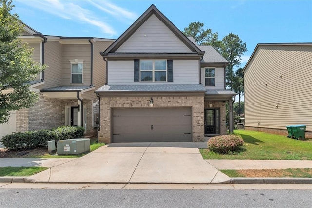 view of front of home with a garage, central AC, and a front yard