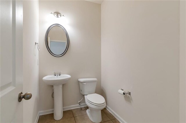 bathroom featuring sink, tile patterned flooring, and toilet