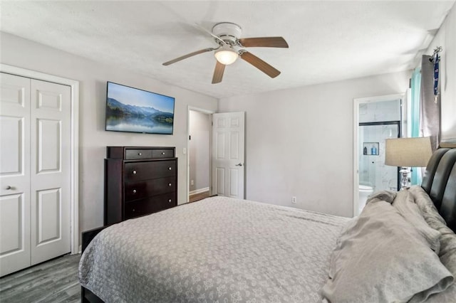 bedroom with a closet, a ceiling fan, a textured ceiling, dark wood-style floors, and ensuite bath