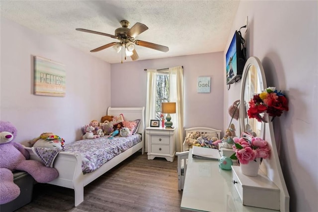 bedroom with a textured ceiling, ceiling fan, and wood finished floors