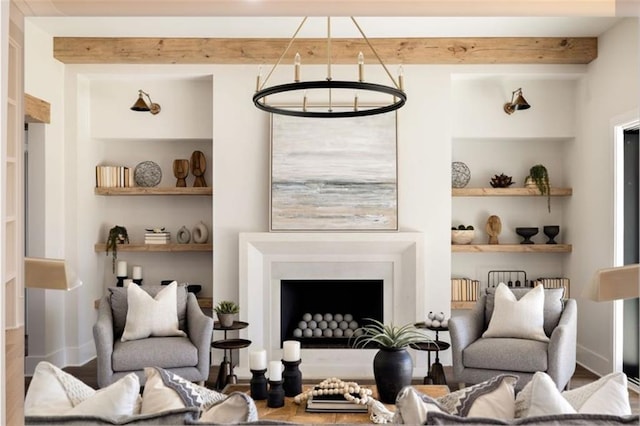 living area featuring baseboards, beamed ceiling, a fireplace, and built in features