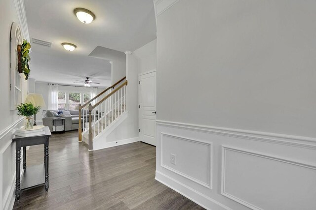 7190 Tributary Ct, Cumming, GA 30040 - stairs with ceiling fan, wood finished floors, a wainscoted wall, and a decorative wall