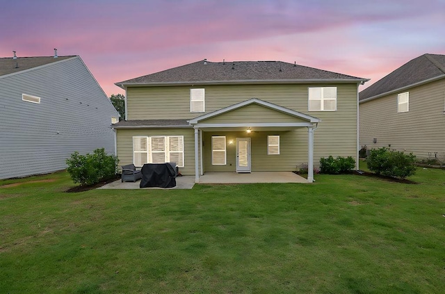 7190 Tributary Ct, Cumming, GA 30040 - back of house at dusk with a patio area and a yard